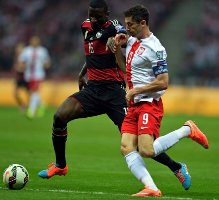 Germany's defender Antonio Ruediger (L) and Poland's forward and captain Robert Lewandowski vie for the ball during the Euro 2016 Group D qualifying football match Poland vs Germany in Warsaw, Poland on October 11, 2014. AFP PHOTO / JANEK SKARZYNSKI