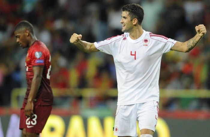 Albania's defender Elseid Hysaj (R) celebrates next to Portugal's midfielder Ivan Cavaleiro at the end of the UEFA EURO 2016 Qualifier football match Portugal vs Albania at the Municipal Stadium in Aveiro on September 7, 2014. Albania won 1-0. AFP PHOTO/ MIGUEL RIOPA / AFP / MIGUEL RIOPA