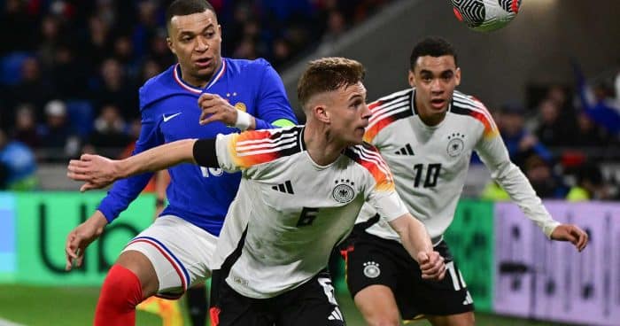 Der deutsche Mittelfeldspieler (06) Joshua Kimmich (C) kämpft mit dem französischen Stürmer (10) Kylian Mbappe (L) während des Freundschaftsspiels zwischen Frankreich und Deutschland am 23. März 2024 im Groupama-Stadion in Decines-Charpieu, in der Nähe von Lyon, um den Ball. (Foto: Olivier CHASSIGNOLE / AFP)