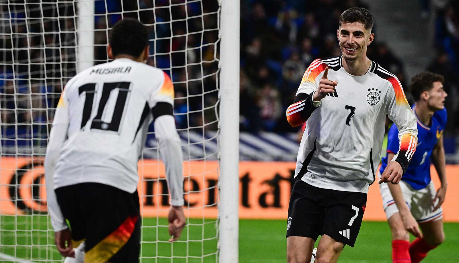 Deutschlands Mittelfeldspieler (Nr. 07) Kai Havertz (R) jubelt nach seinem zweiten Tor mit Deutschlands Stürmer (Nr. 10) Serge Gnabry (L) während des Freundschaftsspiels zwischen Frankreich und Deutschland im Groupama-Stadion in Decines-Charpieu, in der Nähe von Lyon, am 23. März 2024. (Foto: Olivier CHASSIGNOLE / AFP)